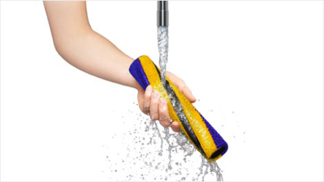 The Fluffy Cleaner bar being rinsed off under a running tap.